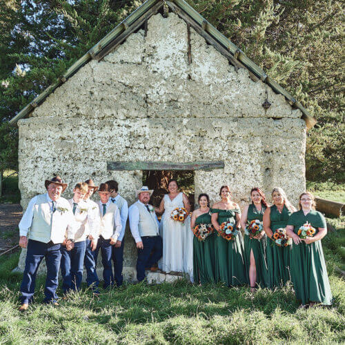 Rural wedding part outside old cob shed, Pleasant Point, New Zealand